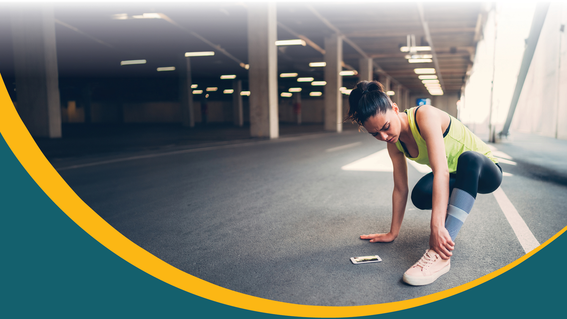 female runner holding ankle